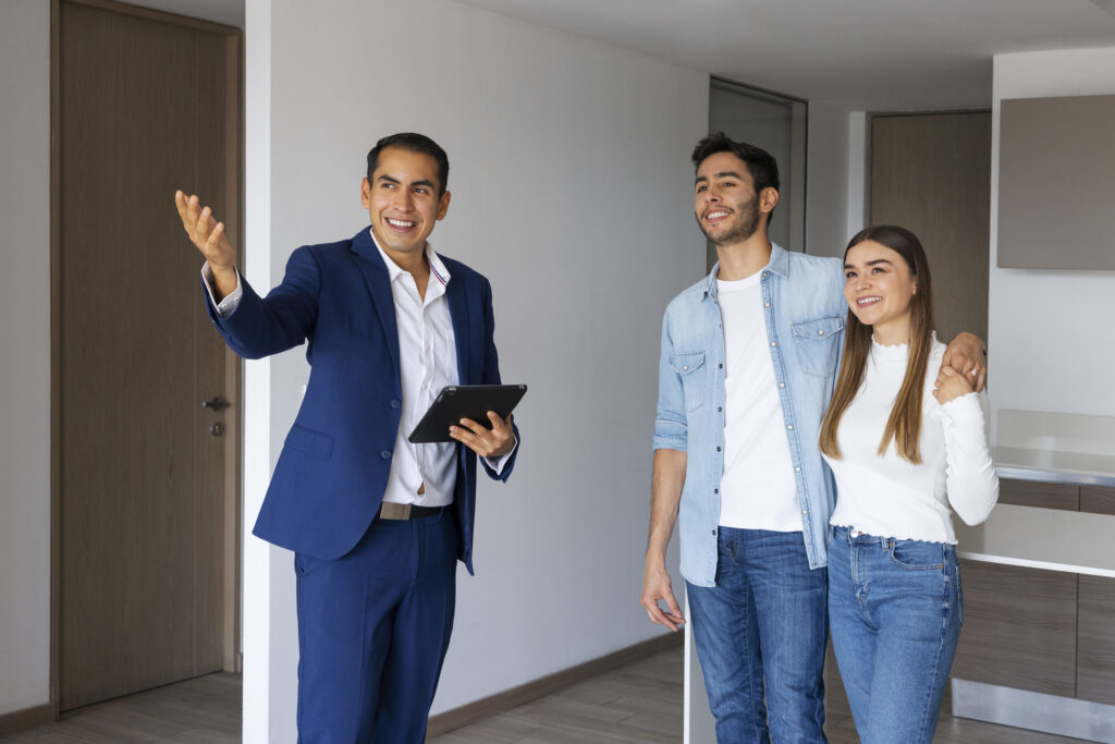 real estate agent showing couple a property in Dubai for buying