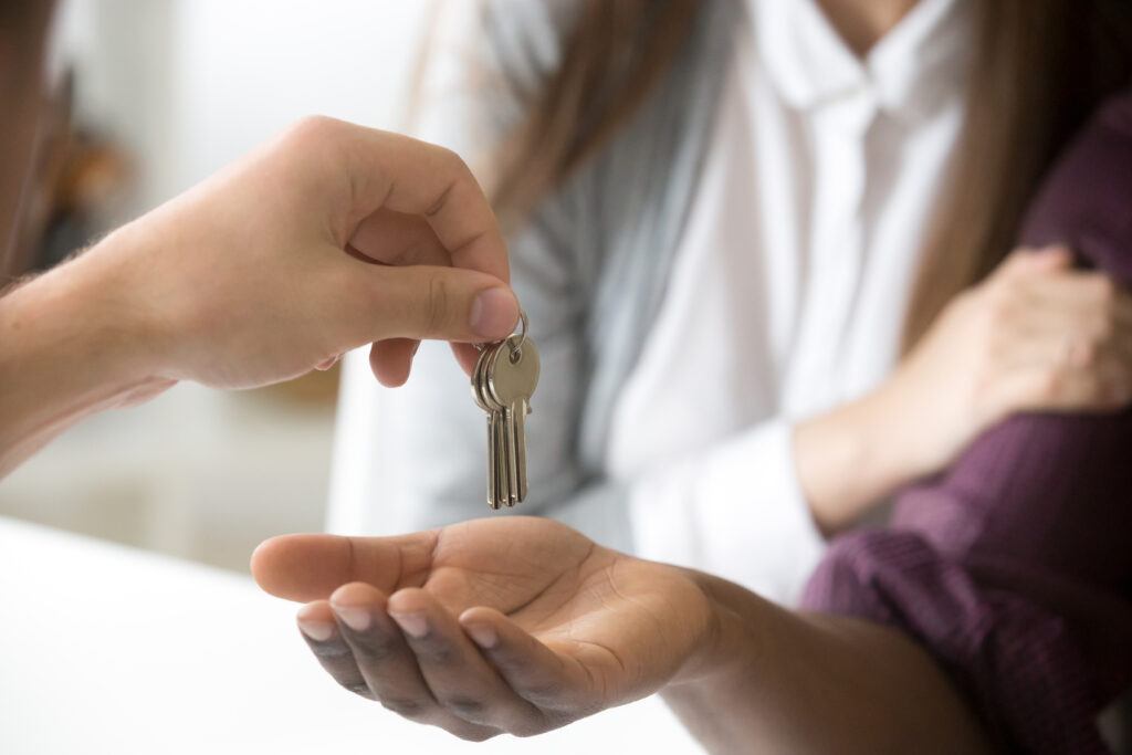 handing keys of freehold property to new homeowners
